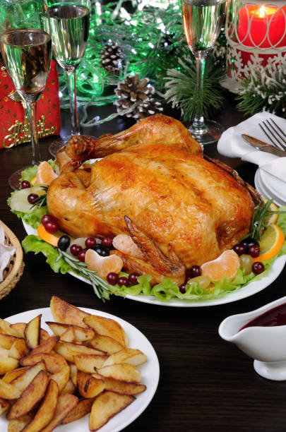 istock Delicate baked chicken   with an appetizing crust with a citrus garnish on the Christmas table 892328556