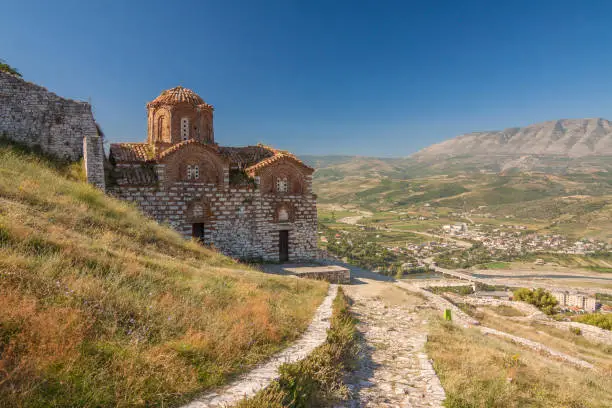 Albania - Berat - Ancient stone orthodox St Trinity church on the hill of old Berat castle with valley behind
