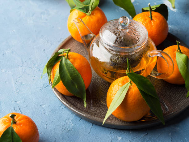 istock Tangerines and green tea still life 892345408