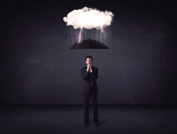 istock Businessman standing with umbrella and little storm cloud 892346224