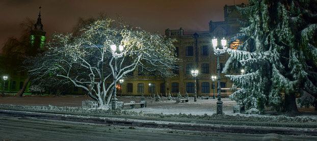 Snowy evening landscape of the city square.