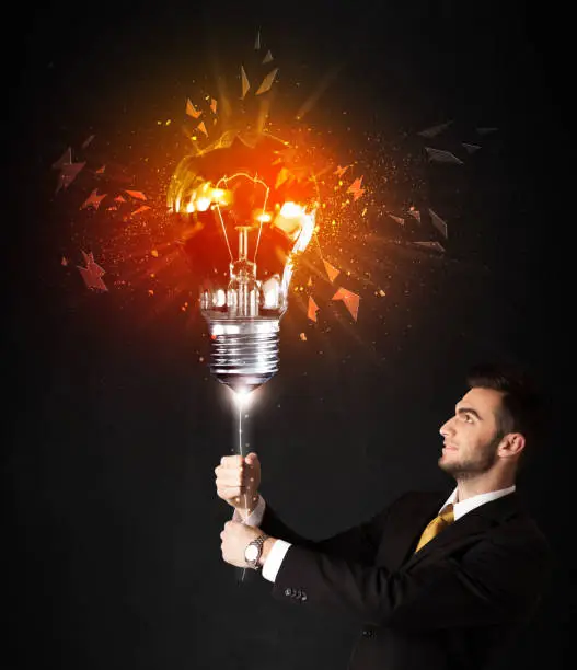 Photo of Businessman with an explosion bulb