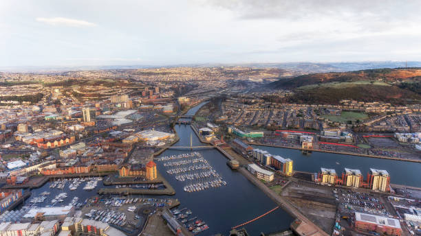 River Tawe in Swansea city Editorial SWANSEA, UK - DECEMBER 12, 2017: An aerial view of the River Tawe in Swansea City, showing the new development around the Prince of Wales Dock, St Thomas, Port Tennant and Kilvey Hill swansea stock pictures, royalty-free photos & images