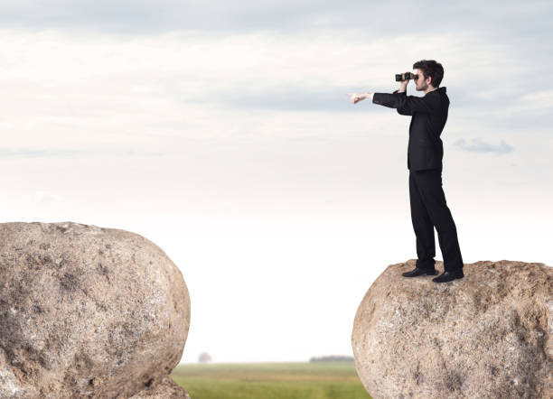 istock Businessman on rock mountain 892357488