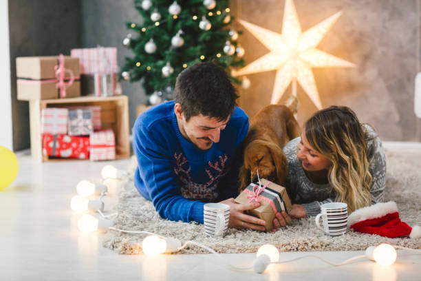 istock Young couple having fun at Christmas time 892357896