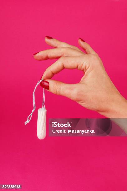 Woman Holding Menstrual Tampon On A Pink Background Menstruation Time Hygiene And Protection Stock Photo - Download Image Now