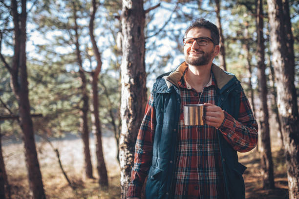 istock Young man holding cup with hot drink 892362538