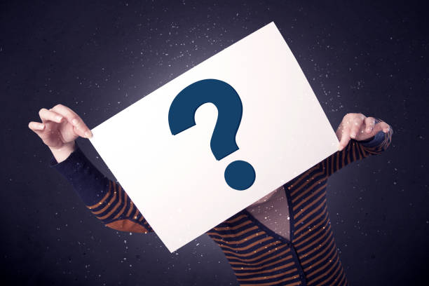 istock Woman holding paper with question marks 892362910
