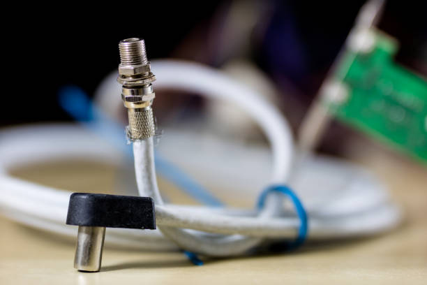 istock old computer wires. Cables lpt, com1 and com2 for desktop and laptop computers. Wooden table, black background. 892363058