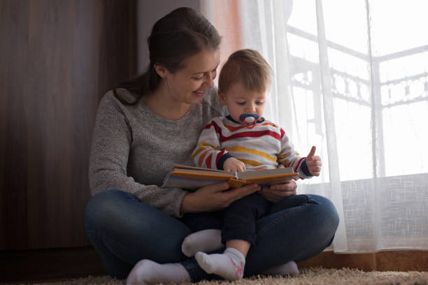 istock Mother and child reading a book 892363334
