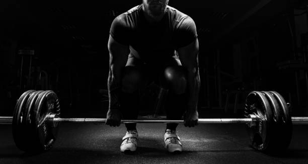 Huge man is preparing to perform an exercise called deadlift. stock photo