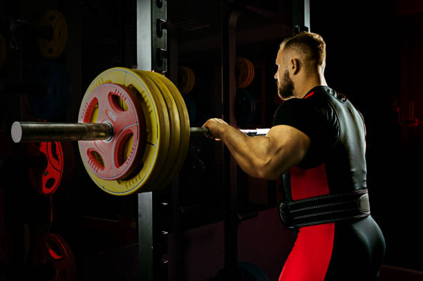 istock Professional athlete prepares to squat with a barbell 892366958