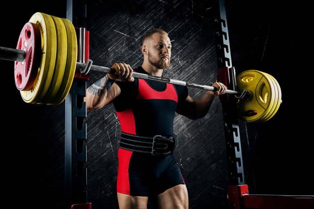 istock Professional athlete prepares to squat with a barbell 892366962