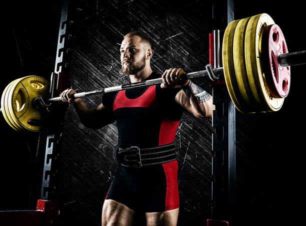 istock Professional athlete prepares to squat with a barbell 892366966