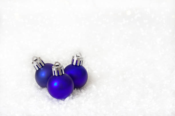 istock Blue christmas balls on white snow background. 892369454