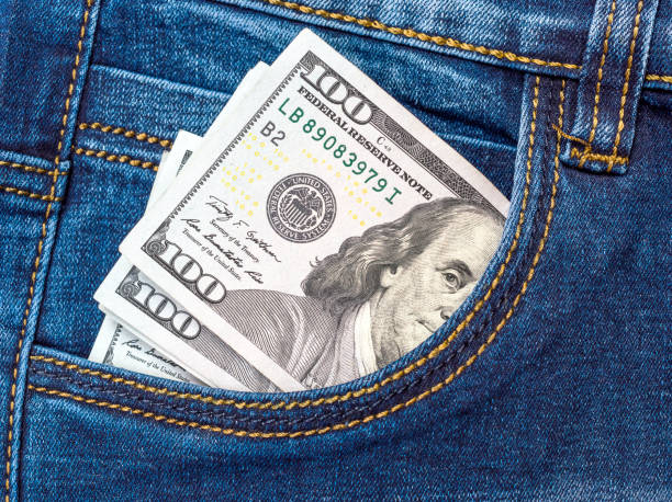 One hundred dollar bills in front pocket of jeans. One hundred dollar bills in front pocket of jeans. american one hundred dollar bill photos stock pictures, royalty-free photos & images