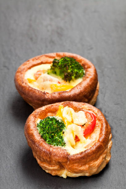 yorkshire  puddings stuffed with broccoli and scrambled eggs on black stone background - yorkshire pudding imagens e fotografias de stock