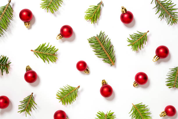 istock Christmas pattern background. Red christmas ornament with branches on a white background. Top view 892370046