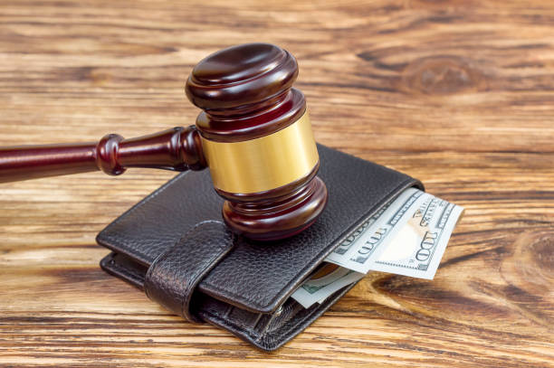 istock Gavel and wallet with money on the table. 892370168