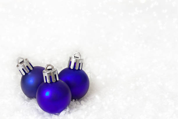 istock Blue christmas balls on white snow background. 892372720