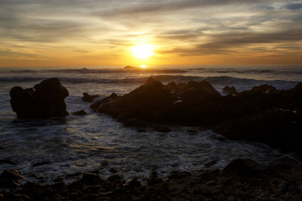 istock Sea waves crashing onto the rocks on sunset 892372838