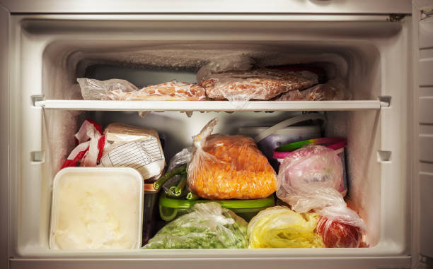 Freezer Interior Various frozen food in freezer, illuminated details. freezer stock pictures, royalty-free photos & images