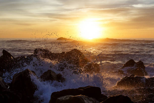 istock Sea waves crashing onto the rocks on sunset 892373048
