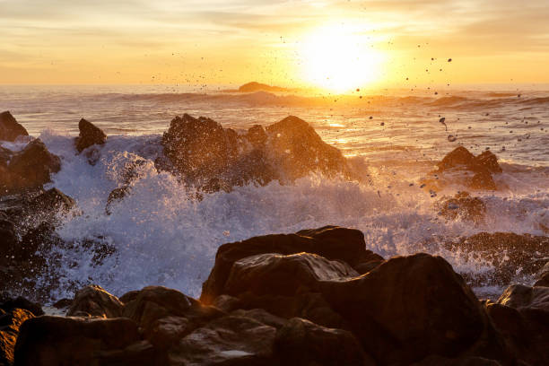 istock Sea waves crashing onto the rocks on sunset 892373230