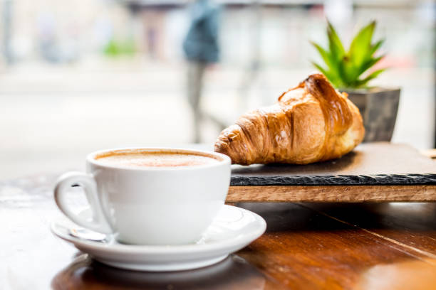 istock Cappuccino and croissant in the cafe 892376188