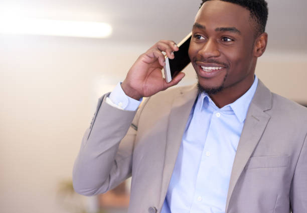 Shot of a young businessman talking on a cellphone in an office