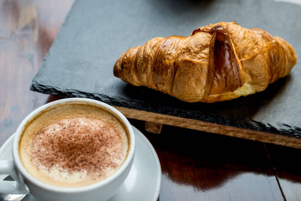 istock Cappuccino and croissant in the cafe 892376276