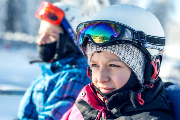 istock Little skiers on the ski lift 892379460