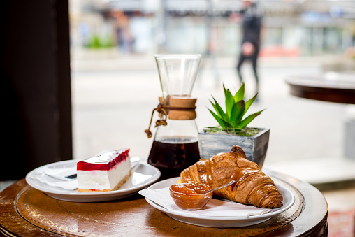 Kemeks coffee, cheesecake and croissant with jam