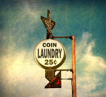 aged and worn coin laundry sign