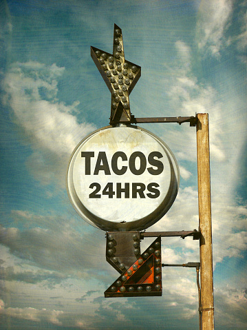 aged and worn tacos sign
