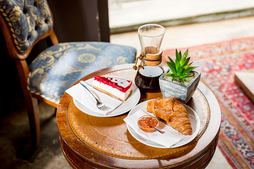 Kemeks coffee, cheesecake and croissant with jam
