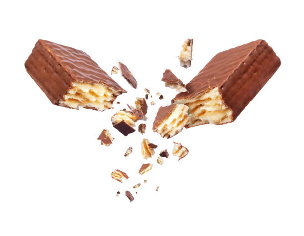 istock Chocolate waffle broken into two parts close up, isolated on white background 892394732