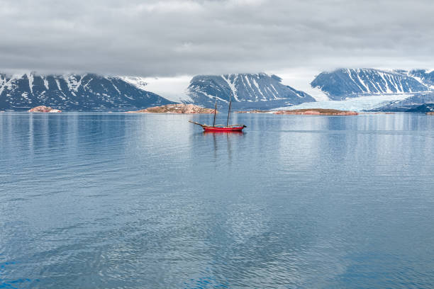 istock Glacier, mountains and sailing ship in Svalbard islands 892394936