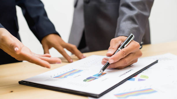 istock Business team working on laptop, while sitting at office. Business people. 892398340