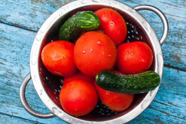 istock Tomatoes and cucumbers in the colander 892403912