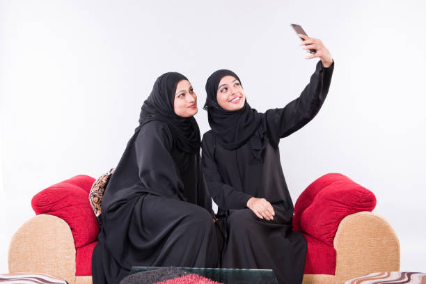 istock two Arab women taking selfie 892406462