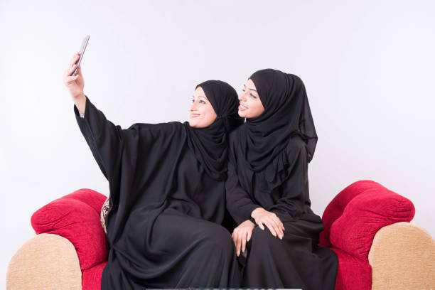 istock two Arab women taking selfie 892406472