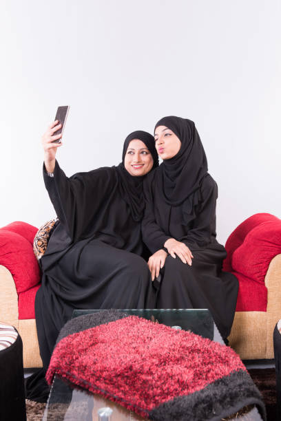 istock two Arab women taking selfie 892406474