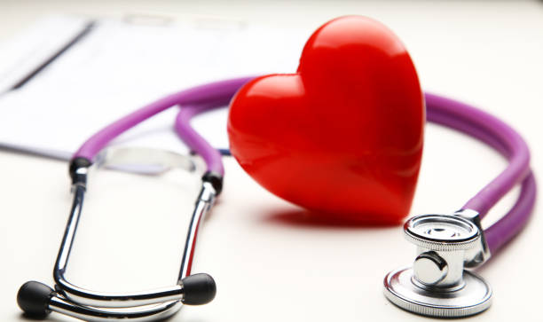 istock Heart with a medical stethoscope, isolated on white background 892423180