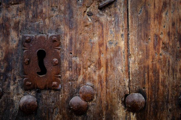 istock Rusty keyhole in old wooden door 892429990