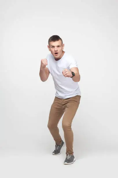 Photo of Boxing. Young blonde man, ready to fight.