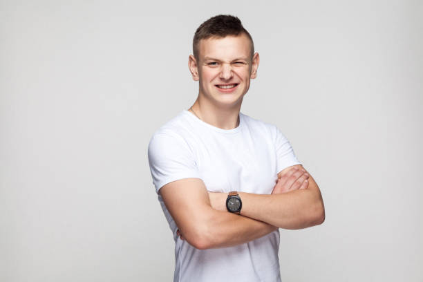istock Boy crossed hands toothy smile and wink at camera 892443980