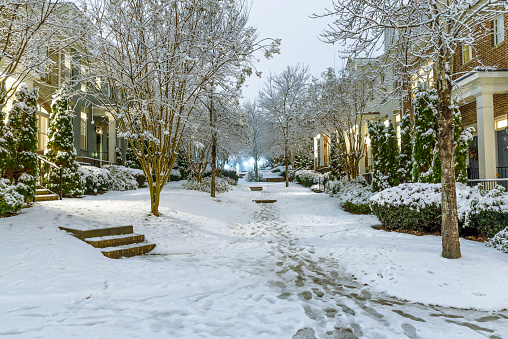 Typical townhouses on United State suburbs with a courtyard in the middle and no numbers showing on the houses on a typical winter wonderland setting, shot in December 2017
