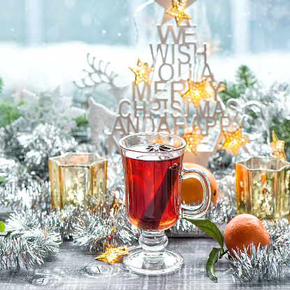 Mulled wine with Christmas window decoration. Winter food and drink