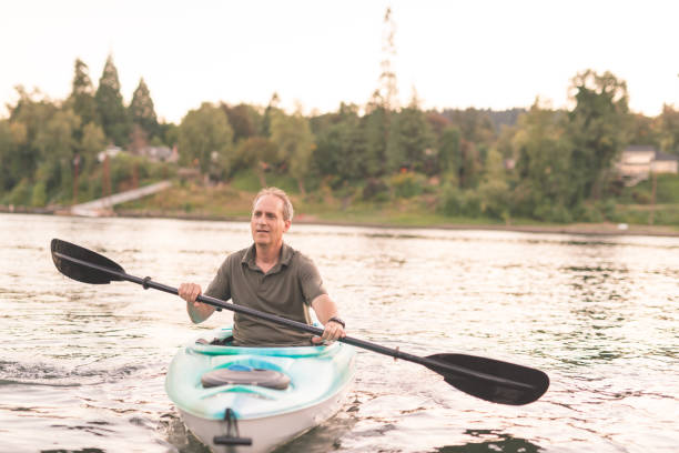 istock An older man kayaks the river on a beautiful summer evening 892455138